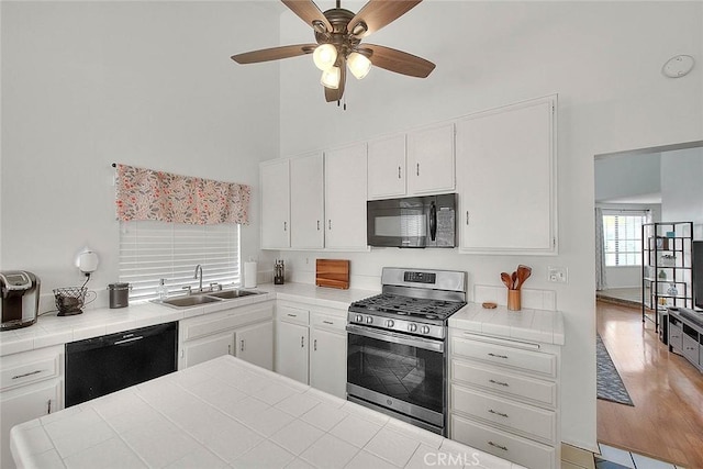 22784 Wren St, Grand Terrace, CA 92313 - kitchen featuring black appliances, a sink, tile countertops, a high ceiling, and a ceiling fan