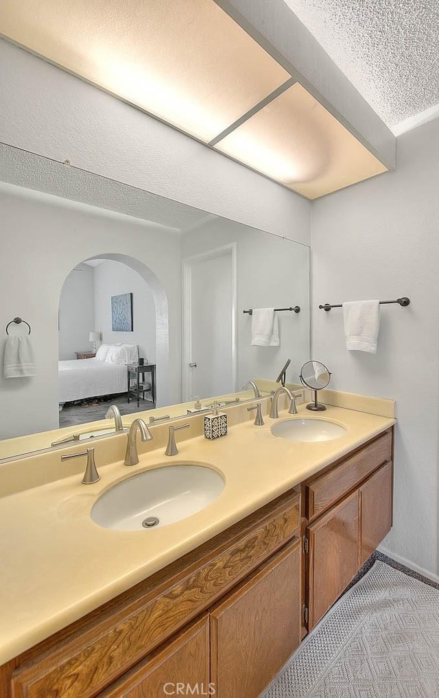 22784 Wren St, Grand Terrace, CA 92313 - ensuite bathroom featuring double vanity and a textured ceiling