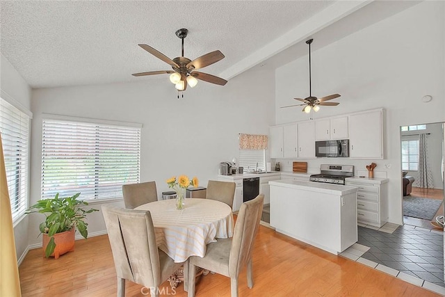 22784 Wren St, Grand Terrace, CA 92313 - dining area featuring vaulted ceiling, a ceiling fan, plenty of natural light, a textured ceiling, and baseboards