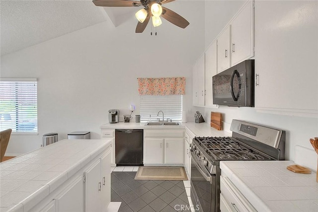 22784 Wren St, Grand Terrace, CA 92313 - kitchen with black appliances, tile counters, a sink, lofted ceiling, and ceiling fan