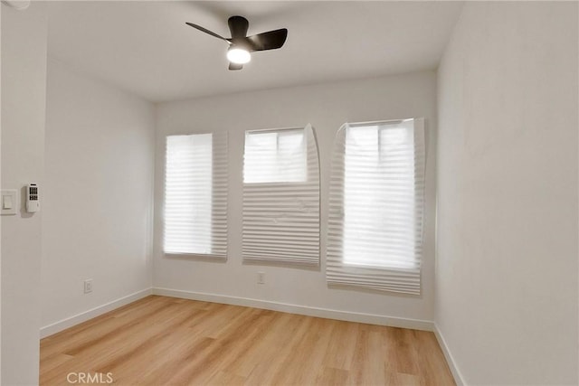 1209 W 40th Pl, Los Angeles, CA 90037 - empty room with wood finished floors, a ceiling fan, and baseboards