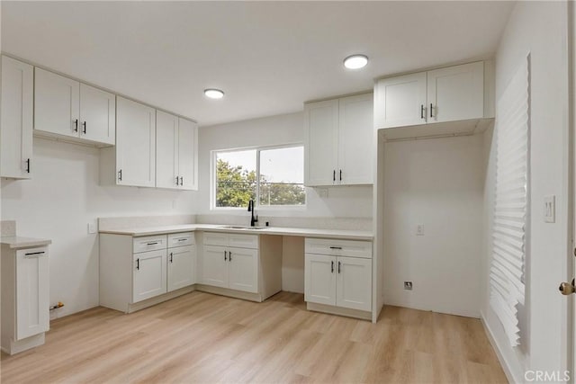 1209 W 40th Pl, Los Angeles, CA 90037 - kitchen with a sink, light wood-type flooring, white cabinetry, and recessed lighting