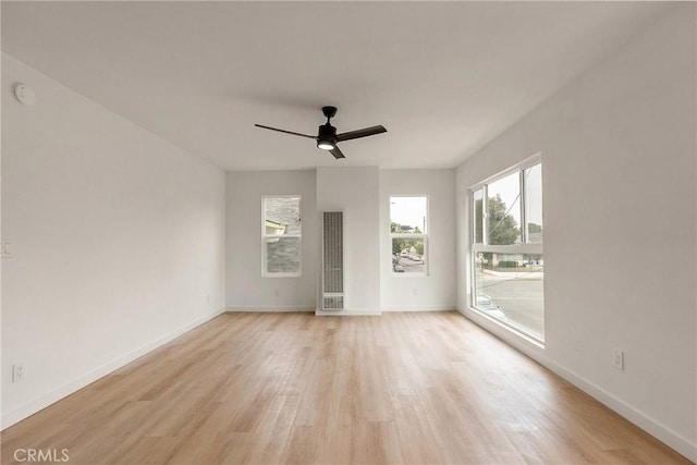 1209 W 40th Pl, Los Angeles, CA 90037 - empty room with light wood-type flooring, a ceiling fan, a heating unit, and baseboards