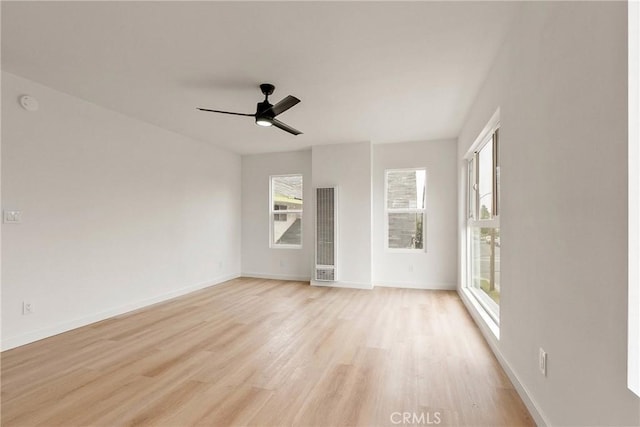 1209 W 40th Pl, Los Angeles, CA 90037 - unfurnished room featuring a heating unit, light wood finished floors, baseboards, and ceiling fan