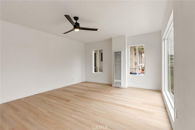 1209 W 40th Pl, Los Angeles, CA 90037 - unfurnished room featuring light wood finished floors, a heating unit, a ceiling fan, and baseboards