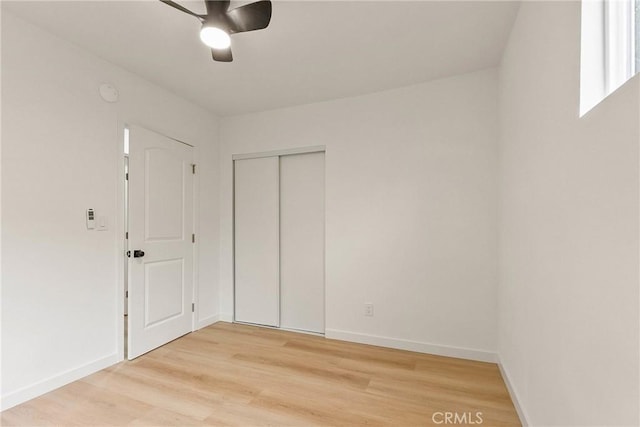 1209 W 40th Pl, Los Angeles, CA 90037 - unfurnished bedroom with light wood-type flooring, baseboards, a closet, and ceiling fan