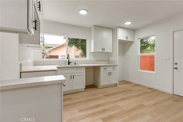 1209 W 40th Pl, Los Angeles, CA 90037 - kitchen featuring a sink, white cabinetry, light wood-type flooring, healthy amount of natural light, and recessed lighting