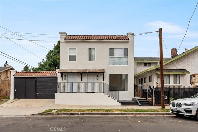 1209 W 40th Pl, Los Angeles, CA 90037 - townhome / multi-family property with a tile roof, stucco siding, and a gate