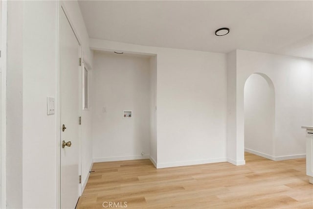 1209 W 40th Pl, Los Angeles, CA 90037 - unfurnished room featuring light wood finished floors, baseboards, and arched walkways