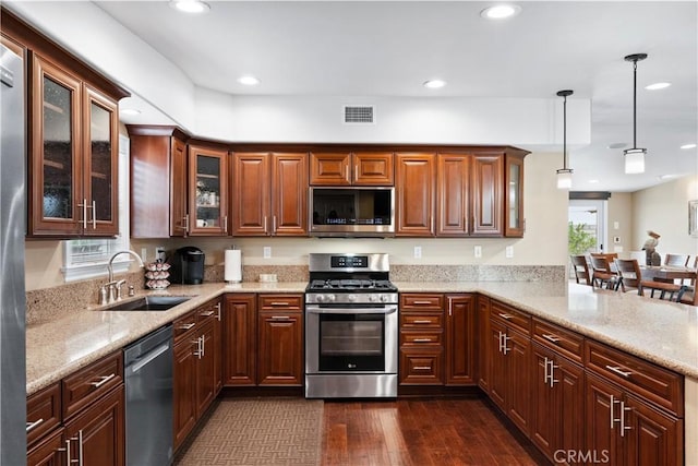 249 Loyola Rd, Costa Mesa, CA 92626 - kitchen with appliances with stainless steel finishes, recessed lighting, dark wood-style floors, decorative light fixtures, and a peninsula
