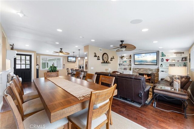 249 Loyola Rd, Costa Mesa, CA 92626 - dining space with a ceiling fan, dark wood-style floors, a fireplace, recessed lighting, and built in features