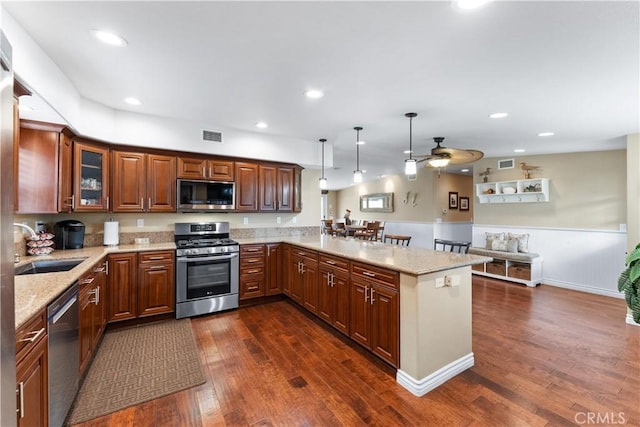 249 Loyola Rd, Costa Mesa, CA 92626 - kitchen featuring stainless steel appliances, a sink, dark wood-style flooring, a peninsula, and light stone countertops