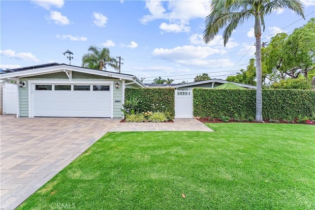 249 Loyola Rd, Costa Mesa, CA 92626 - view of yard with decorative driveway and an attached garage