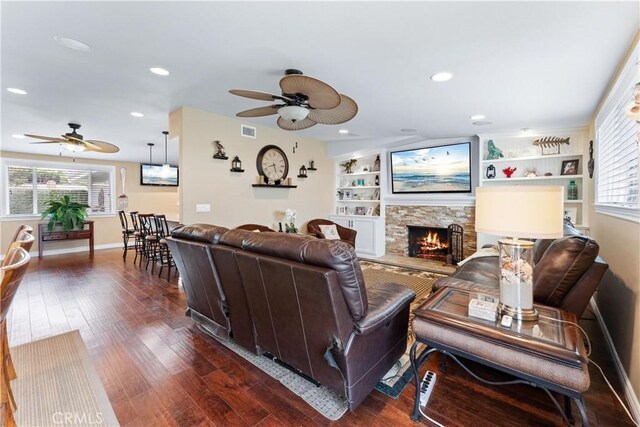 249 Loyola Rd, Costa Mesa, CA 92626 - living area featuring ceiling fan, dark wood-style flooring, baseboards, a stone fireplace, and recessed lighting