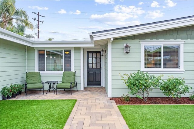 249 Loyola Rd, Costa Mesa, CA 92626 - doorway to property with a yard and a patio area
