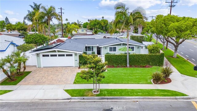 249 Loyola Rd, Costa Mesa, CA 92626 - ranch-style house with decorative driveway, a garage, solar panels, and a residential view