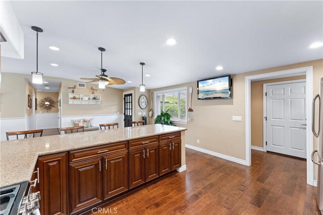 249 Loyola Rd, Costa Mesa, CA 92626 - kitchen with a ceiling fan, dark wood finished floors, range, pendant lighting, and light stone countertops