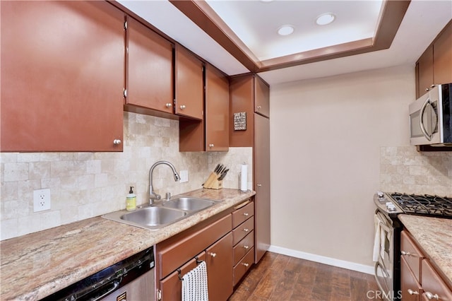 7068 Cerritos Ave Unit 16, Stanton, CA 90680 - kitchen with stainless steel appliances, a sink, decorative backsplash, light countertops, and dark wood-style flooring