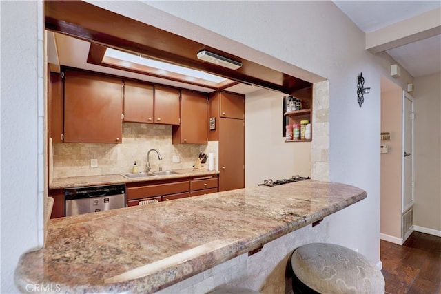 7068 Cerritos Ave Unit 16, Stanton, CA 90680 - kitchen featuring a sink, stainless steel dishwasher, dark wood finished floors, and a peninsula