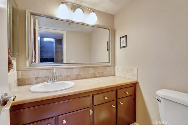 7068 Cerritos Ave Unit 16, Stanton, CA 90680 - bathroom featuring vanity, toilet, and decorative backsplash
