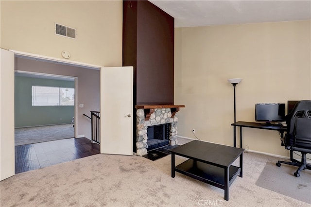 7068 Cerritos Ave Unit 16, Stanton, CA 90680 - carpeted office featuring a high ceiling, baseboards, a fireplace, and wood finished floors