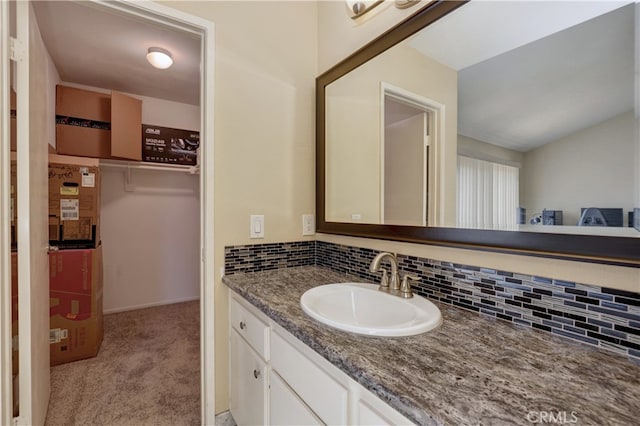 7068 Cerritos Ave Unit 16, Stanton, CA 90680 - bathroom featuring backsplash, vanity, and lofted ceiling