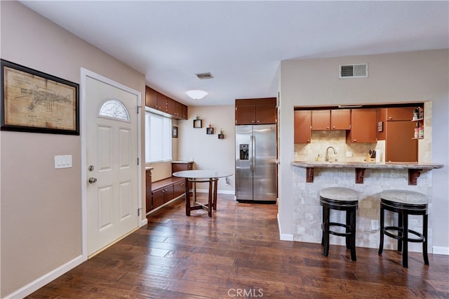 7068 Cerritos Ave Unit 16, Stanton, CA 90680 - kitchen with stainless steel fridge, dark wood finished floors, a kitchen bar, and baseboards