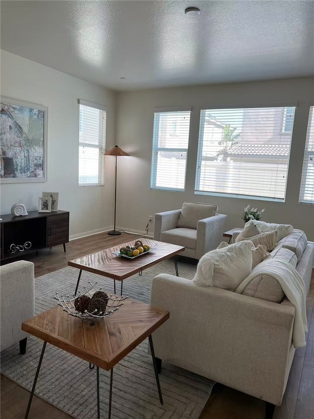 7739 Lupin St, Chino, CA 91708 - living room featuring baseboards, wood finished floors, and a textured ceiling