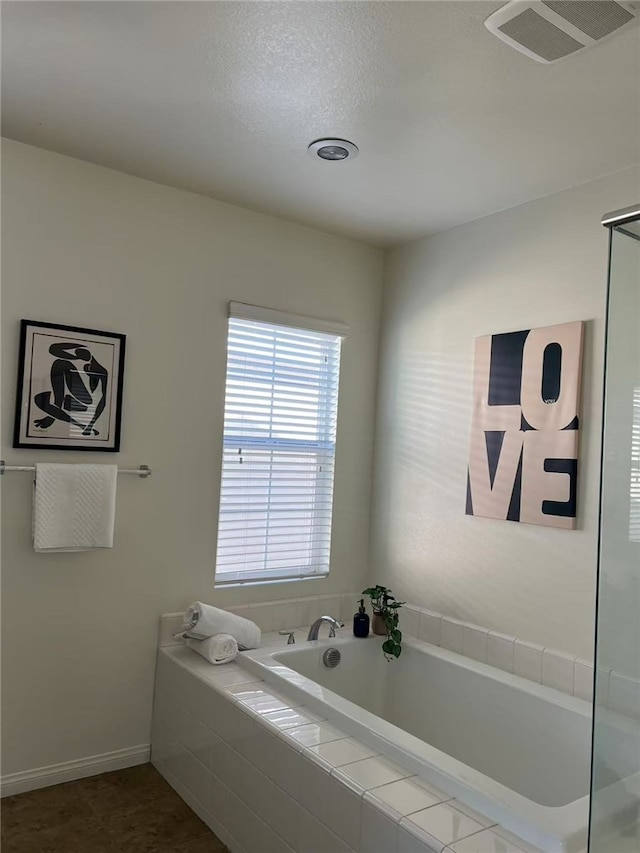 7739 Lupin St, Chino, CA 91708 - full bathroom with a garden tub and baseboards