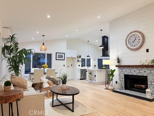 1254 W Van Koevering St, Rialto, CA 92376 - living area featuring lofted ceiling, a fireplace, light wood-style flooring, and recessed lighting