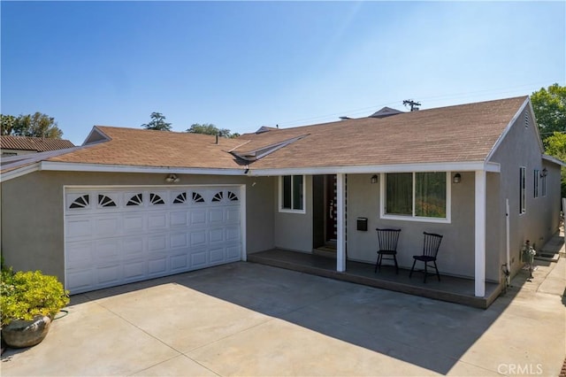 5427 Noble Ave, Sherman Oaks, CA 91411 - single story home with stucco siding, concrete driveway, roof with shingles, an attached garage, and a porch