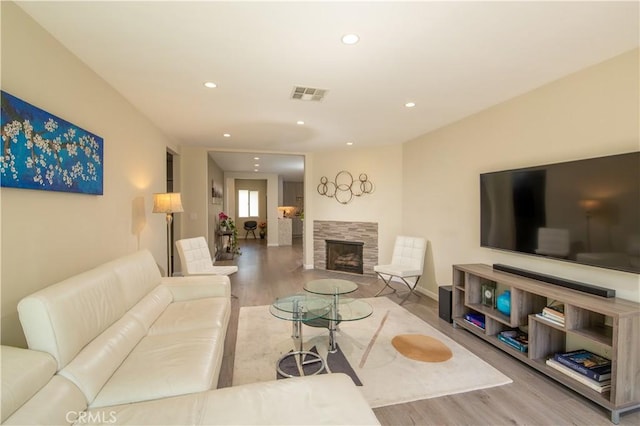 5427 Noble Ave, Sherman Oaks, CA 91411 - living room with wood finished floors, recessed lighting, and a tiled fireplace