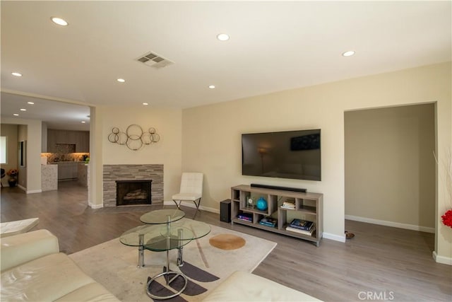 5427 Noble Ave, Sherman Oaks, CA 91411 - living room featuring recessed lighting, wood finished floors, and a tile fireplace