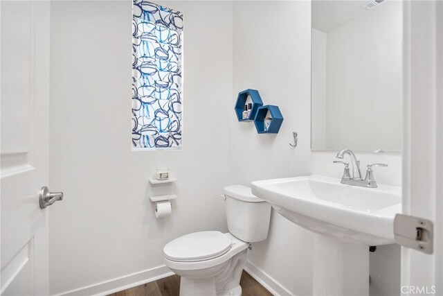 39376 Corvina Ln, Temecula, CA 92591 - bathroom with baseboards, toilet, and wood finished floors