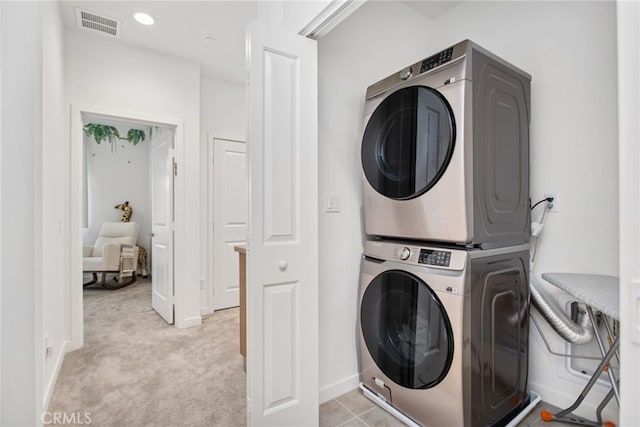 39376 Corvina Ln, Temecula, CA 92591 - laundry room with stacked washer / dryer and light colored carpet