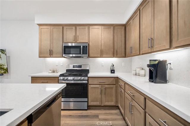 39376 Corvina Ln, Temecula, CA 92591 - kitchen with appliances with stainless steel finishes, light countertops, and light wood-style flooring