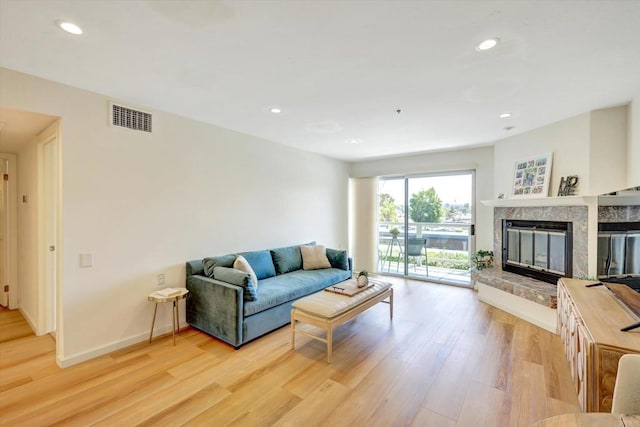 1616 Circa Del Lago Unit C206, San Marcos, CA 92078 - living area with light wood-style flooring, a high end fireplace, recessed lighting, and baseboards