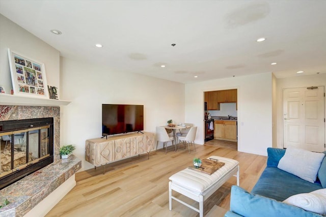 1616 Circa Del Lago Unit C206, San Marcos, CA 92078 - living area featuring recessed lighting, light wood-style floors, a high end fireplace, and baseboards