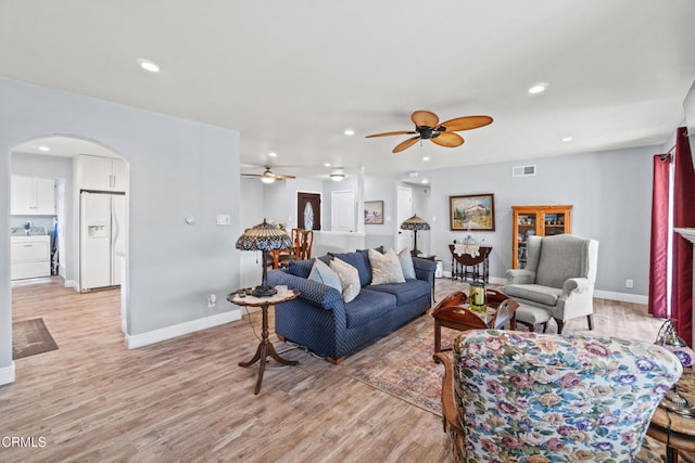1350 Elder St, Oxnard, CA 93036 - living area featuring arched walkways, ceiling fan, light wood-style floors, recessed lighting, and washer / clothes dryer