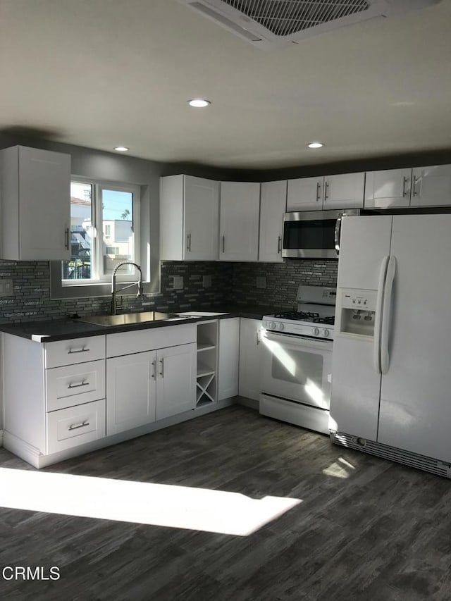 1350 Elder St, Oxnard, CA 93036 - kitchen featuring white appliances, dark countertops, backsplash, dark wood-type flooring, and recessed lighting