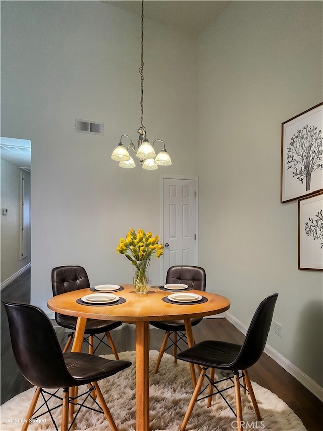 27971 Sarabande Ln Unit 230, Canyon Country, CA 91387 - dining room with a towering ceiling, a chandelier, and wood finished floors