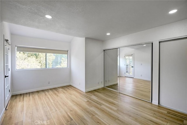 23391 Park Sorrento Unit 62, Calabasas, CA 91302 - unfurnished bedroom with baseboards, light wood finished floors, recessed lighting, and a textured ceiling