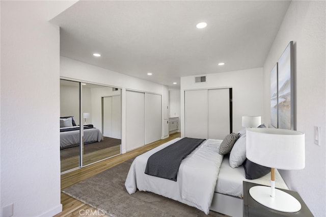 23391 Park Sorrento Unit 62, Calabasas, CA 91302 - bedroom with wood finished floors, multiple closets, and recessed lighting