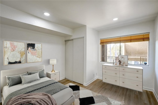 23391 Park Sorrento Unit 62, Calabasas, CA 91302 - bedroom with baseboards, wood finished floors, a closet, and recessed lighting