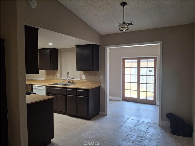 1260 Mirage Dr, Barstow, CA 92311 - kitchen with a sink, dishwasher, light countertops, backsplash, and light tile patterned floors