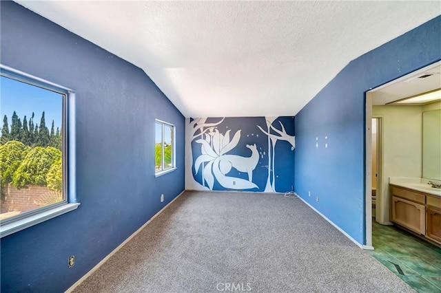 3065 Sabre St, Rosamond, CA 93560 - unfurnished bedroom featuring lofted ceiling, a textured ceiling, carpet floors, and baseboards