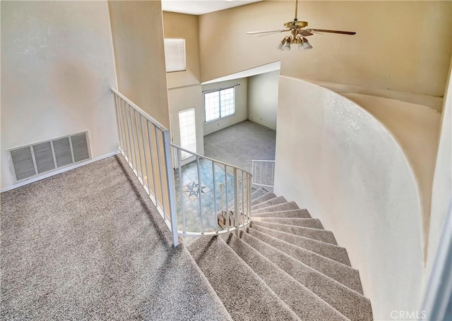 3065 Sabre St, Rosamond, CA 93560 - stairway with carpet floors, a towering ceiling, and ceiling fan