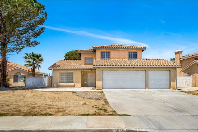 3065 Sabre St, Rosamond, CA 93560 - mediterranean / spanish house with driveway, stucco siding, a garage, a tiled roof, and a gate