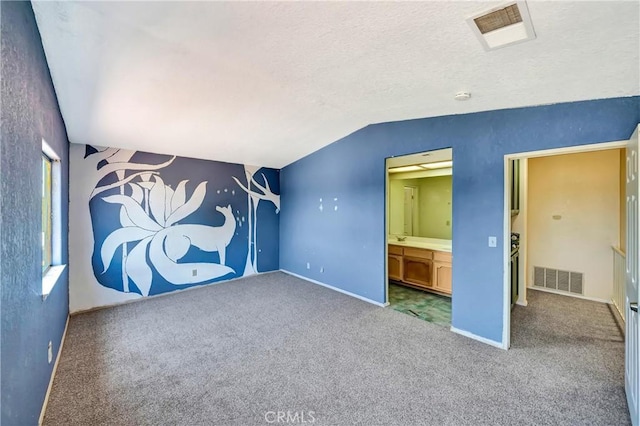 3065 Sabre St, Rosamond, CA 93560 - unfurnished bedroom featuring lofted ceiling, carpet, baseboards, connected bathroom, and a textured ceiling