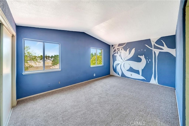 3065 Sabre St, Rosamond, CA 93560 - unfurnished room with a textured ceiling, carpet flooring, lofted ceiling, and baseboards